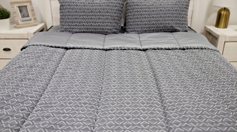 An intense close up of a Jameson-style Beddy's zipper bedding product that mostly focuses on the comforter with the two pillow cases visible in the top part of the image. 