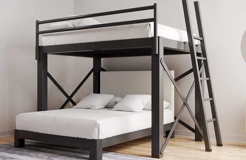A Charcoal colored Queen Over Queen L-Shaped Bunk Bed for adults in a light, neutral, sparsely decorated room seen from a low angle the lower left-hand corner of the bottom bunk.