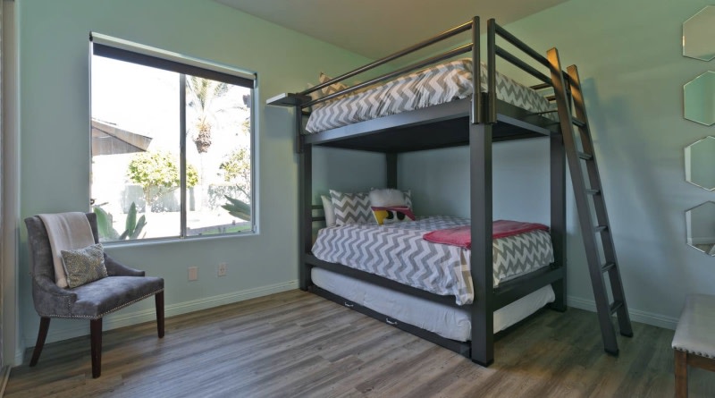 Charcoal Queen Over Queen Adult Bunk Bed in a vacation rental in the Coachella Valley, Southern California. There is a matching trundle accessory.
