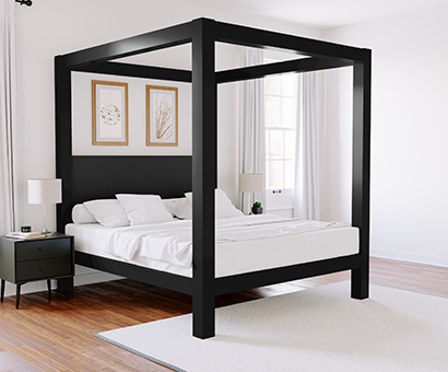 Black king size metal Canopy Bed with a Graphite headboard seen in a nice upscale room from the lower-right hand corner of the bed. All-white bedding.