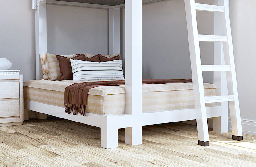 Davis-style (tan with white vertical stripes) zipper bedding covering the bottom bunk mattress on a white Full XL Over Queen Adult Bunk Bed seen at a close angle from the right-hand corner.