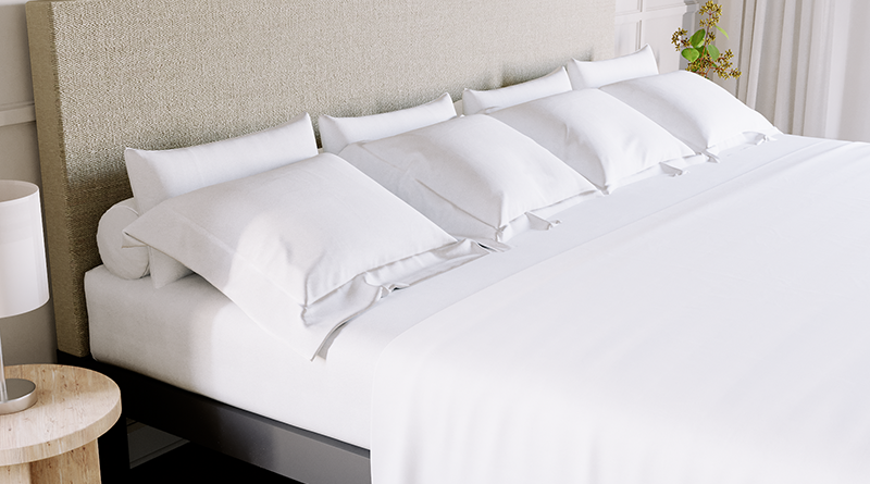 Alaskan King size Platform Bed with beige headboard and white Bamboo Sheet Set. Seen from the right-hand side of the bed at a close distance.