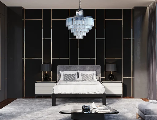 A black queen size metal Platform Bed with grey and black bedding and a gray headboard inside a luxury high rise apartment with modern furniture. During the daytime. Seen directly from the foot of the bed.