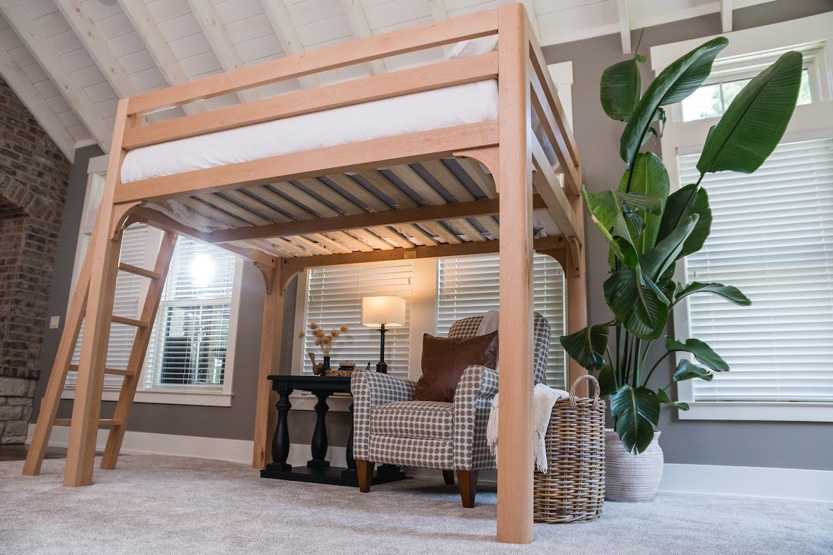 Solid wood loft bed for adults against a stone accent wall