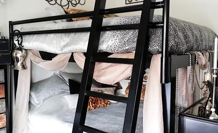 A black Queen Over Queen Adult Bunk Bed in a bedroom