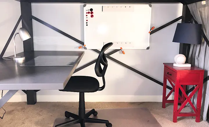Underneath an Adult Loft Bed with an attached desk accessory. Decorated to look like a home office.
