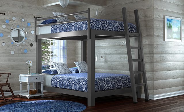 A charcoal Queen Over Queen Adult Bunk bed in a rustic cabin seen from a direct angle facing the lower right hand corner of the bed.