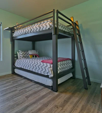 A charcoal Adult Bunk Bed with a trundle in the bedroom of a high end vacation rental in Coachella Valley, CA. Seen from the lower right hand corner.
