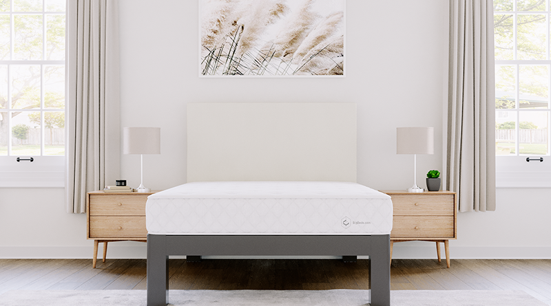 Full size version of the BigBeds.com Luxe Slumber Hybrid mattress on a charcoal Full Platform Bed with an Ivory headboard seen directly from the foot of the bed.