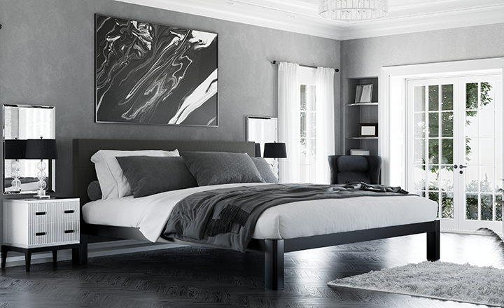 Black Alaskan King Bed in a high-end luxury bedroom with mostly gray and black and white decor seen from the right-hand corner at the foot of the bed.