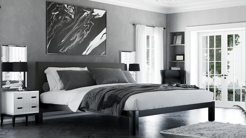Black Alaskan King Bed in a high-end luxury bedroom with mostly gray and black and white decor seen from the right-hand corner at the foot of the bed.