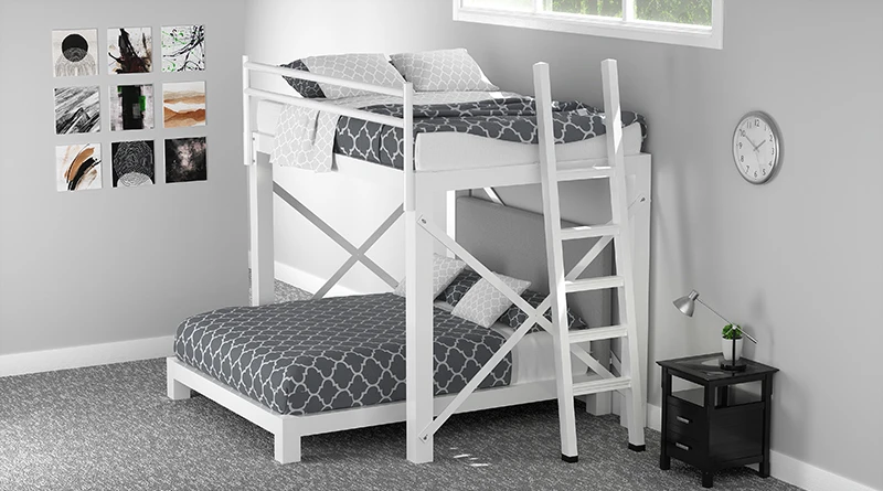 A white Full Over Queen L-Shaped Bunk Bed with light gray bedding in a basement guest room with gray walls. Seen from a top-down angle facing the bottom left end bed post of the top bunk.