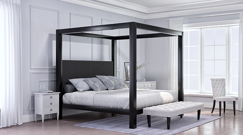 A black Wyoming King size metal four poster Canopy Bed in a minimalist but luxury master bedroom with mostly white and light-colored furniture. Seen from the lower right-hand corner of the bed.