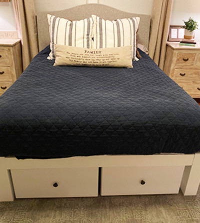 Two white drawers underneath a white queen size platform Standard Bed