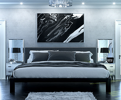 A black metal Alaskan King size platform bed with a gray headboard and various shades of gray bedding in a high end luxury master suite seen directly from the foot of the bed.