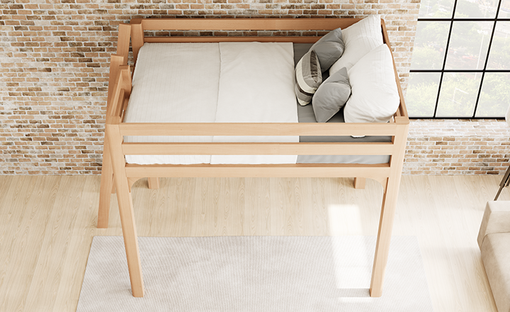 Light colored queen size Wood Loft Bed for Adults in an urban loft-style apartment with light exposed brick walls with a lot of natural lighting. Bed has white and light gray bedding on it. Seen from a high angle looking down from the left-hand side of the loft bed frame.