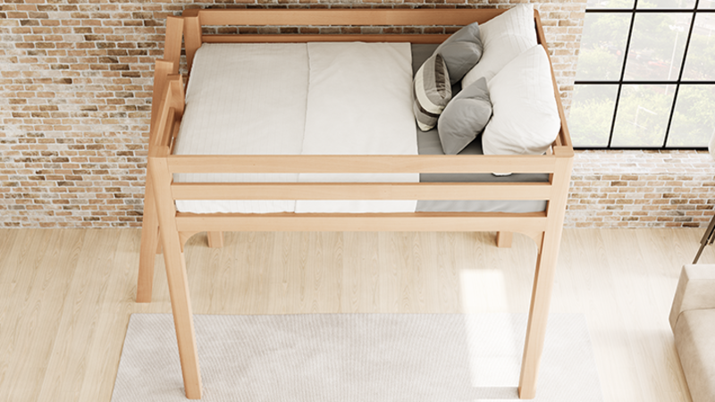 Light colored queen size Wood Loft Bed for Adults in an urban loft-style apartment with light exposed brick walls with a lot of natural lighting. Bed has white and light gray bedding on it. Seen from a high angle looking down from the left-hand side of the loft bed frame.