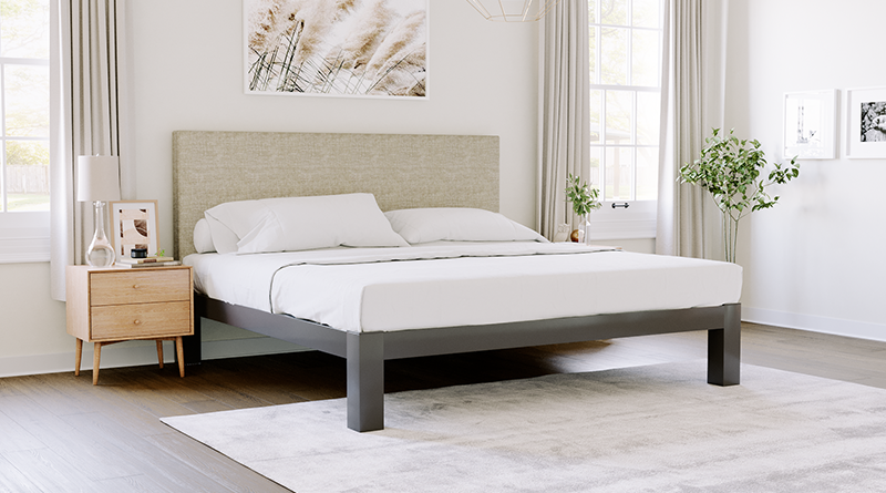 Charcoal Wyoming King size metal Platform Bed with an Oatmeal headboard seen in an upscale but not opulent master bedroom decorated in nice neutral tones. Camera facing the lower left-hand corner of the bed.