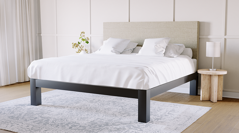 A King size metal Platform Bed with a beige headboard and a white duvet on top tucked in around the mattress with four white pillows.