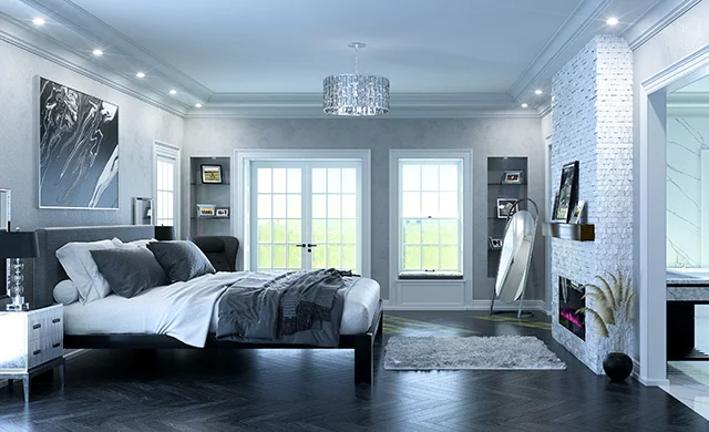 A black Alaskan King size metal Platform Bed with a dark gray headboard in a super luxurious master suite decorated in muted grays, blacks, and whites. Seen here directly from the right-hand side of the bed at a slight distance.