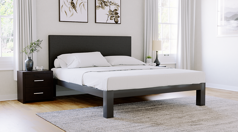 Charcoal Texas King size metal Platform Bed with a Charcoal fabric headboard seen in an upscale light and neutral master bedroom from the corner angle of the left-hand side.