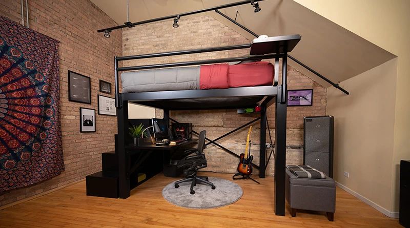 A black queen size Adult Loft Bed with a gamer setup underneath seen from the side at a wide, low angle.