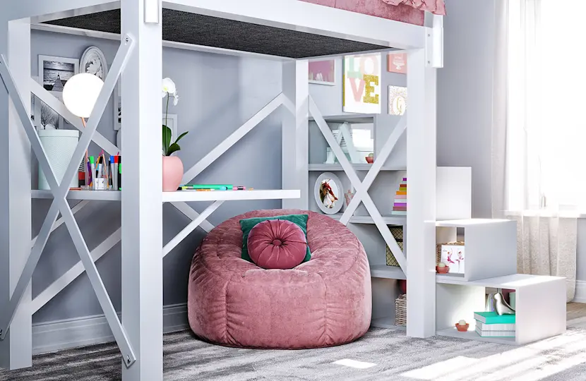 A cozy bedroom corner featuring a white loft bed with a built-in desk and shelves. There's a pink bean bag chair under the bed, and decorative items on the shelves. Soft natural light filters through a nearby window.