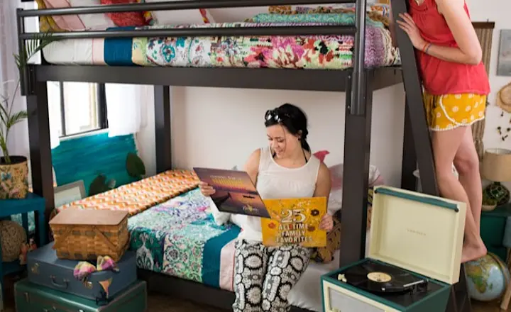 Two Women on a charcoal Queen Over Queen Adult Bunk Bed
