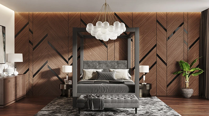A light bronze California king size metal canopy bed in a large and opulent master bedroom with stylized brown walls seen directly from the foot of the bed.