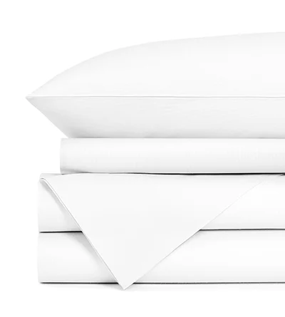 A white sheet set folded and stacked up on top of itself.
