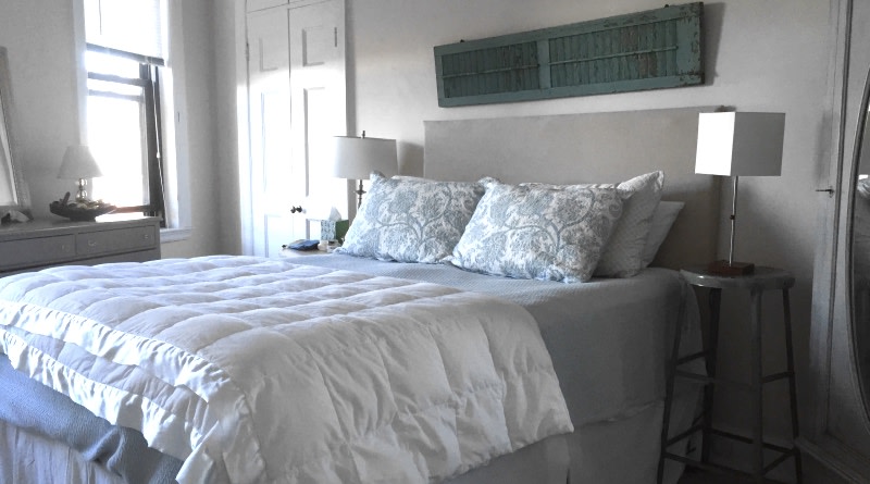 A Queen Size Standard platform bed in a bedroom with rustic decor
