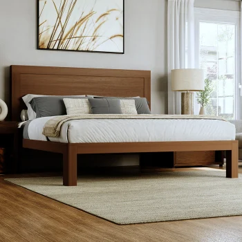 Light colored king size wooden platform bed frame in a nice upscale room with light gray and white bedding seen from the lower right-hand corner of the bed.