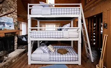 White Queen Triple Bunk Bed for adults in a high end cabin seen directly from the left-hand side of the bed.