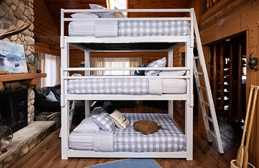 White Queen Triple Bunk Bed for adults in a high end cabin seen directly from the left-hand side of the bed.