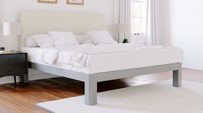 Light gray king size metal platform bed with and Ivory headboard seen from the lower right-hand corner.