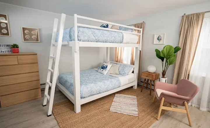 A white Adult Bunk Bed in a light and airy vacation rental on the beach.