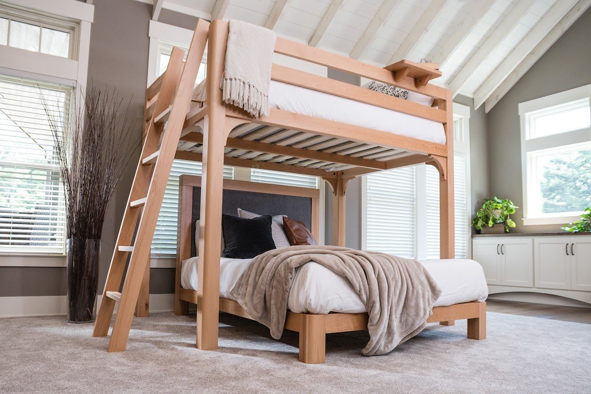 Warm natural beech L-shaped bunk bed in a styled guest room