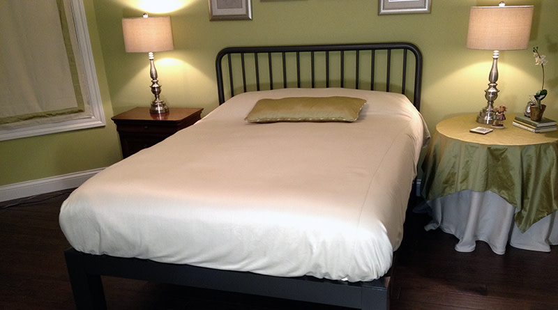 A black Standard bed with a farmhouse style headboard