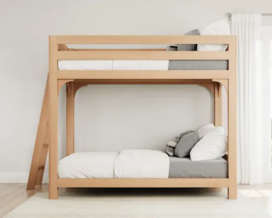 Light colored queen over queen size Wood Bunk Bed for Adults in a nice, airy room with a lot of natural light seen directly from the left-hand side of the bed frame.