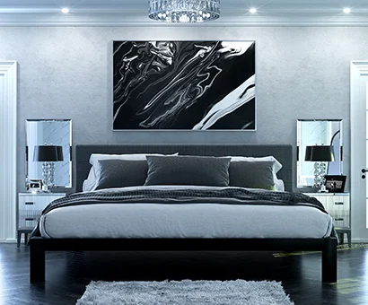 A black Alaskan King size metal Platform Bed with a dark gray headboard in a super luxurious master suite decorated in muted grays, blacks, and whites. Seen here directly from the foot of the bed.