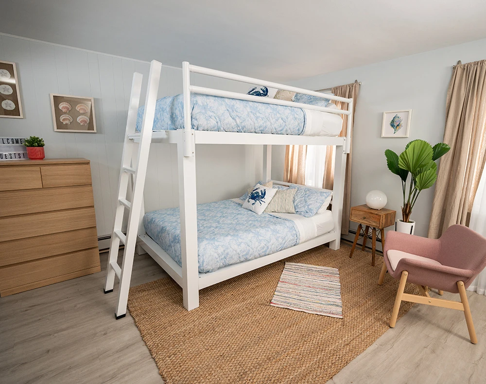 A white Queen Over Queen Bunk Bed in a vacation rental beach house