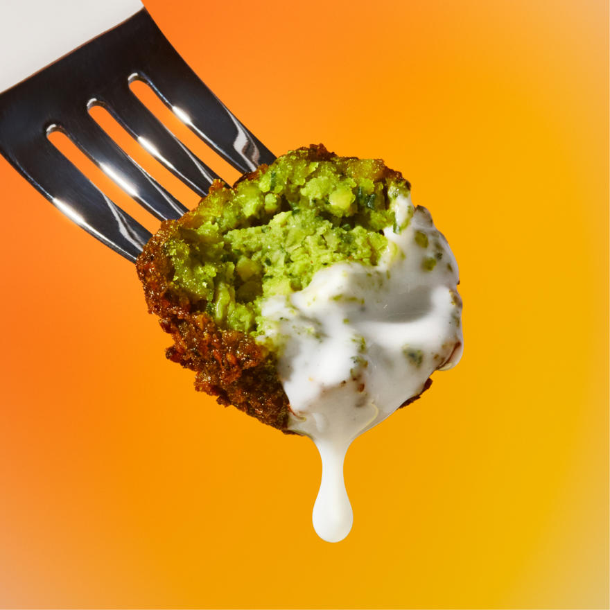 Spicy Falafel on a fork dipped in garlic dressing