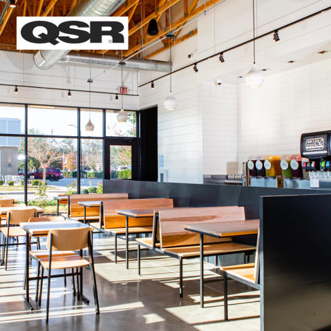 QSR logo on a photo of the interior of a new CAVA restaurant