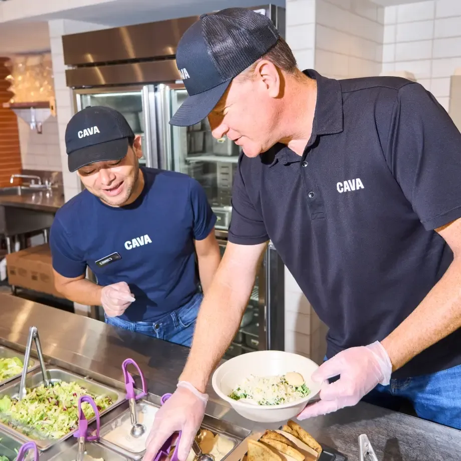 Two CAVA team members assembling bowls.