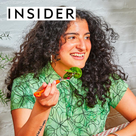 Business Insider logo on a photo of a woman eating CAVA