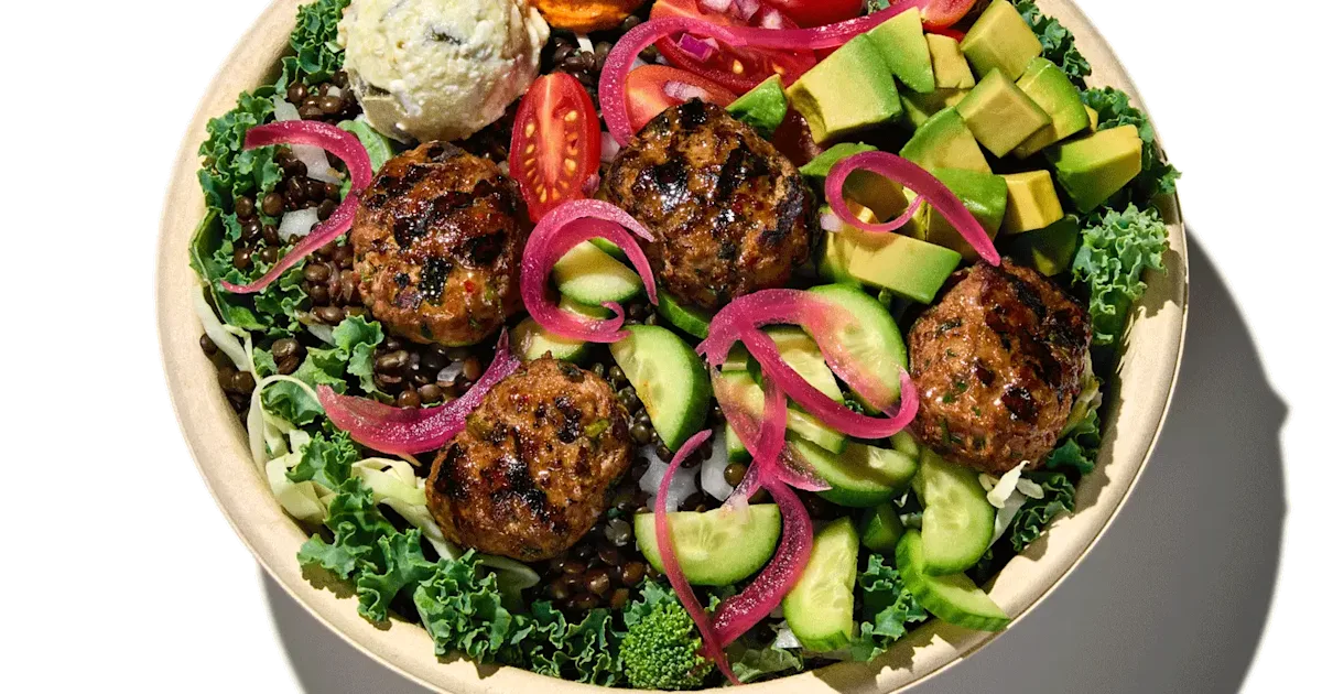 CAVA Spicy Lamb and Avocado Bowl with lamb meatballs, avocado, dips, vegetables, greens, lentils, and tahini