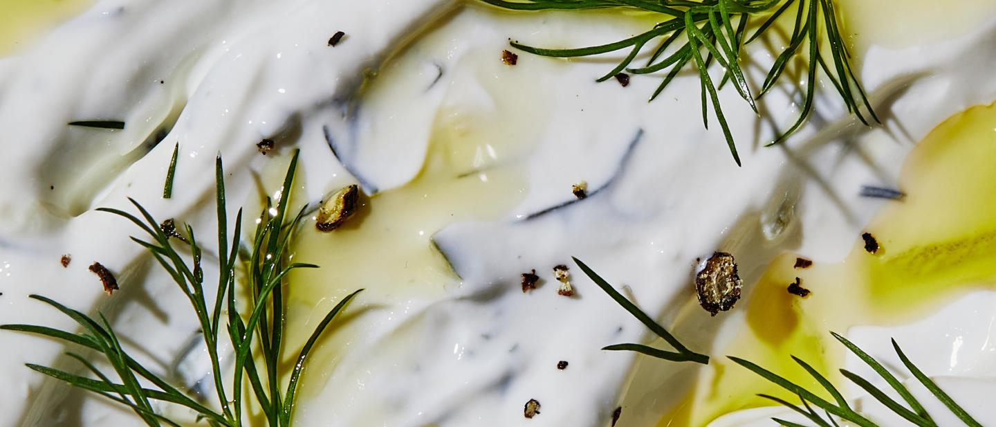 Tzatziki up close with dill and crushed pepper