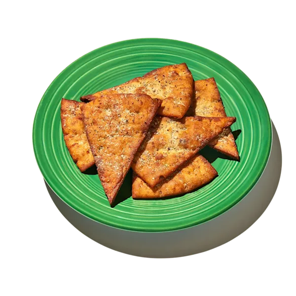 Sumac Sour Cream and Onion Pita Chips on a green plate