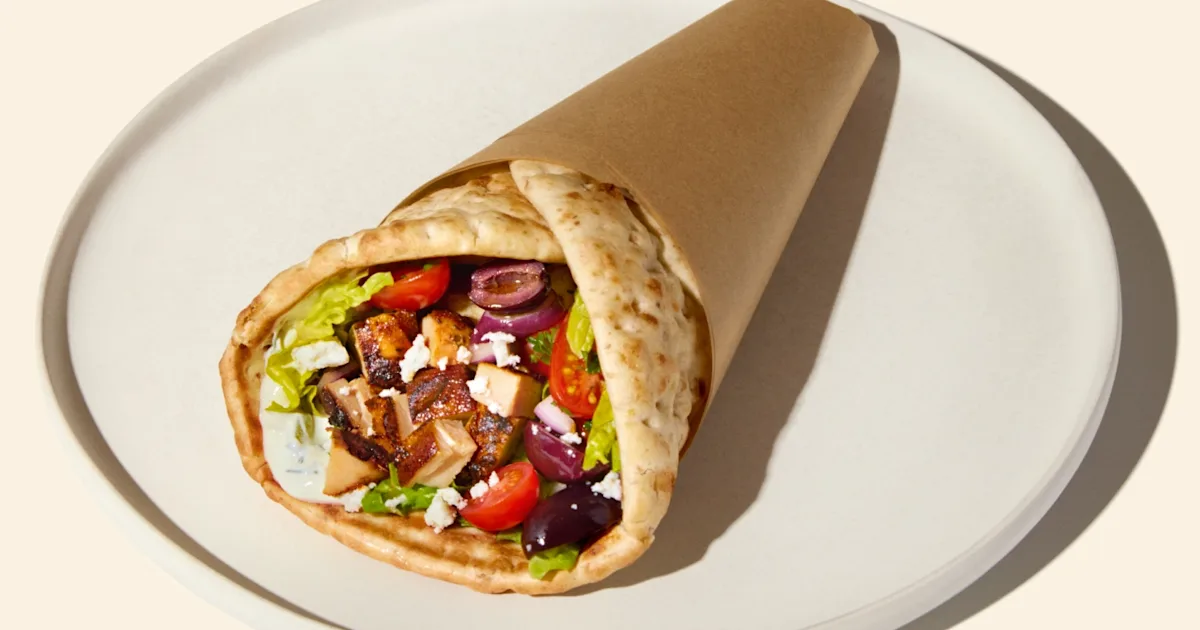 CAVA Greek Chicken Pita with grilled chicken, tzatziki, tomato and onion, olives, feta, romaine, and yogurt dill dressing