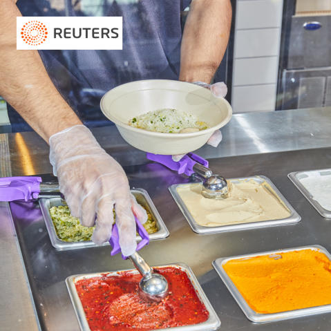 Reuters logo on a photo of a CAVA employee scooping Harissa onto a bowl